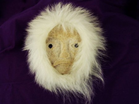 Eskimo Mask: Ca. 1970s, Hand carved interior whale bone wall mask in human form with inliad eyes and fur trim, signed "C.B. Oozeva Sr." Very good condition. 7" x 5" plus 3" "hair"