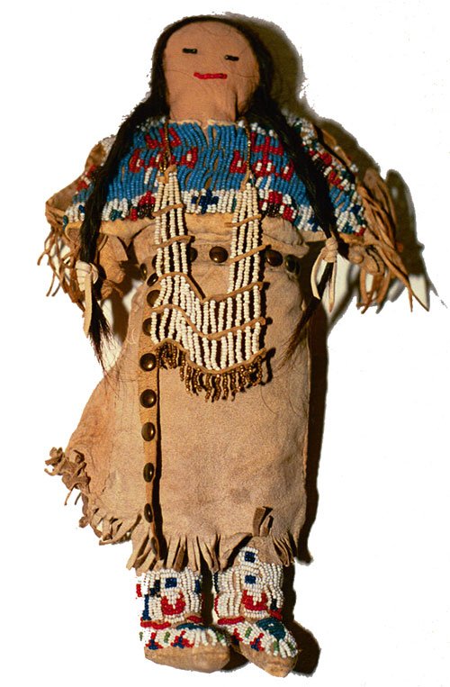 Sioux Doll: Circa 1900 Female doll with human hair, beaded yoke, hide dress, moccasins, leggings, and breast plate. 11-1/2" x 6"