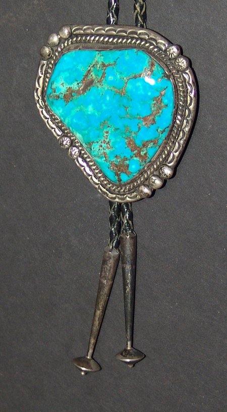 Navajo Bolo Tie - Manuel Benally: Ca. 1970s, Outstanding large Stormy Mountain turquoise and silver bolo tie. Very good condition. 37" long, bolo 2-3/4" x 2-1/2"