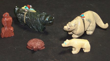 5 Zuni Fetishes: Late 1900s, Collection of five hand carved stone fetishes, a large bear with medicine bundle, a long tailed animal with medicine bundle signed "RV," a small bear signed "KP," a small pipestone owl mar