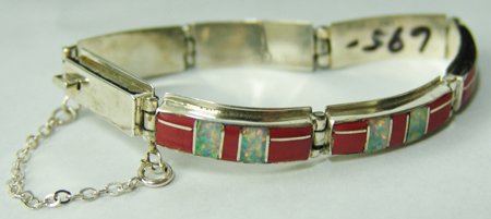 Zuni Inlay Bracelet: Late 1900s, Contemporary all-silver segment bracelet set with beautiful coral and opaline stones. Signed "LB." Very good condition. 7" x 3/8"