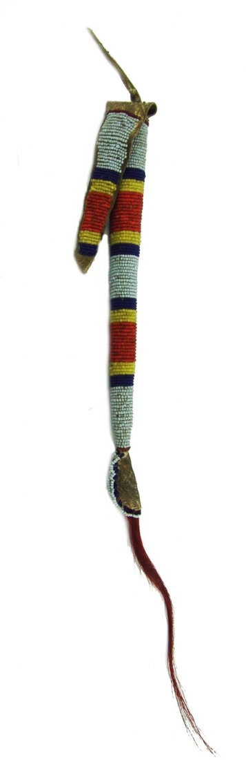 Blackfoot Awl Case: Early/Mid 1900s, Beautiful round beaded shaped rawhide awl case with buckskin flap and dyed horsehair tail. Good to very good condition. 9-1/2" + hair