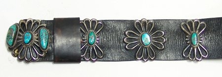 Navajo Concho Belt: Ca. 1950, Classic sandcast design turquoise and silver concho belt with five rosette conchos and matching buckle, plus five butterfly spacers. Very good used condition, some stones have small cracks. 