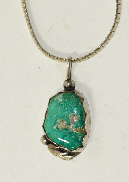 Navajo Pendant Necklace: Late 1900s, Fine hand wrought flat silver chain with a single turquoise stone pendant. Very good condition. 19" long, pendant 1-1/4" x 1/2"