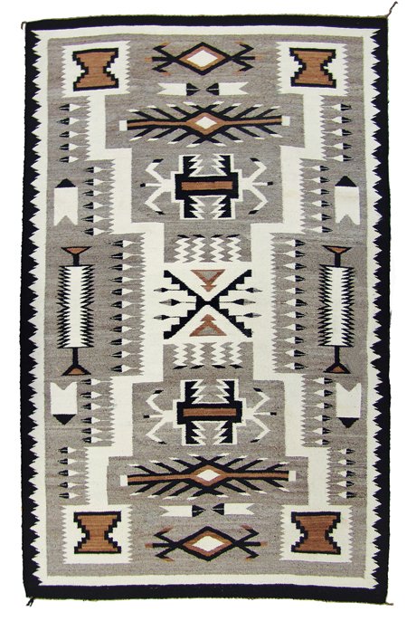 Navajo Rug/Weaving: Mid 1900s, Fantastic finer weave earth tone storm pattern rug with many feathers in the traditional design. Very good condition. 48" x 79"