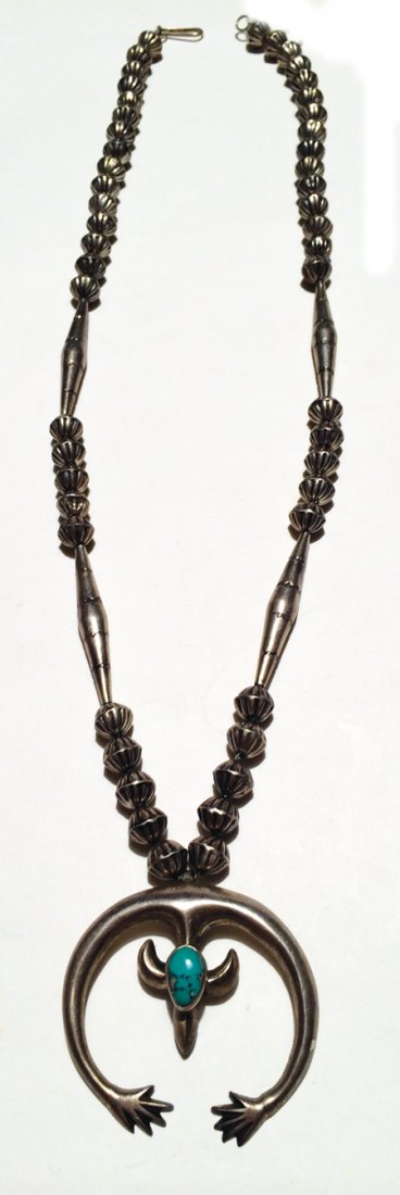 Navajo Necklace: Mid 1900s, Classic all sterling silver squash blossom necklace with hand wrought stamped beads and sand cast naja with early hand design and natural turquoise cabochon. 29" long, naja 2" x 2"