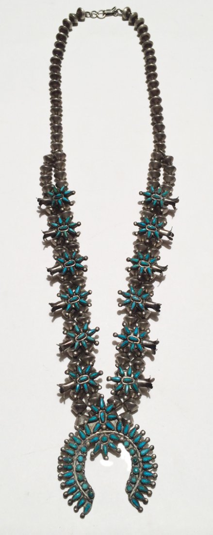 Zuni Necklace: Mid 1900s, Zuni needlepoint turquoise and silver squash blossom necklace on double strand of stamped hand wrought beads. 26" long, naja 2" x 1-3/4"