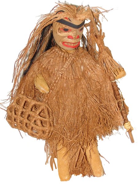 NW Coast Doll - Lisa Marie David: Ca. 1980s, Hand crafted original doll display "Herb Gatherer" with woven cedar fiber shawl and basket and hand carved and painted cedar wood face. Very good condition. From the Herb and Peggy Puffer C