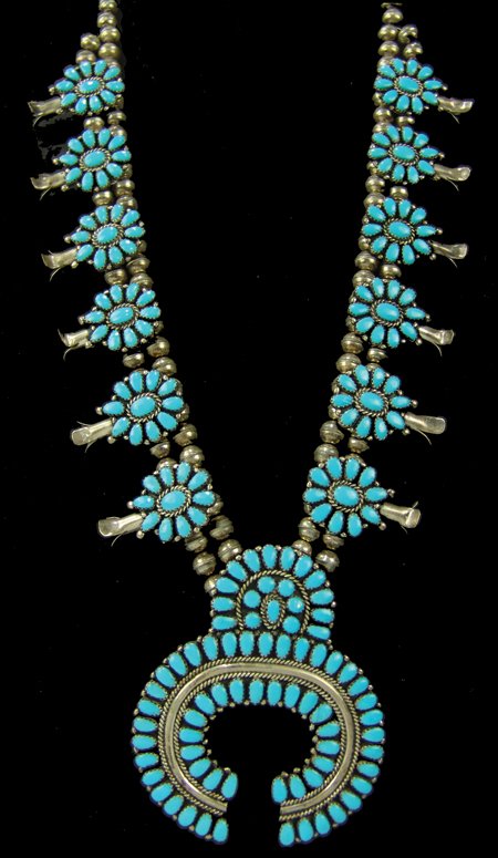 Navajo Necklace - Larry Moses Begay: Ca. 1980s, Outstanding turquoise and silver cluster-style squash blossom necklace with 206 hand-cut and set matching stones. Very good condition, signed "LMB." 35" long, naja 3" x 3"