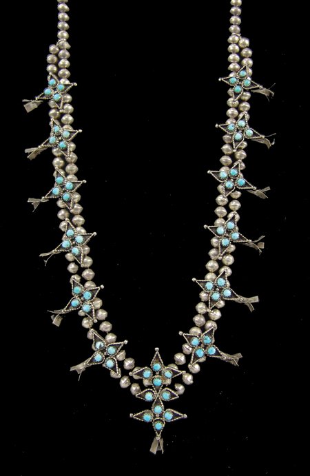 Zuni Necklace: Ca. 1970s, Fine vintage turquoise and silver petit point squash blossom necklace made with four-point star sections. Very good condition, nice patina. 29" long, naja 2-3/8" x 1-1/4"