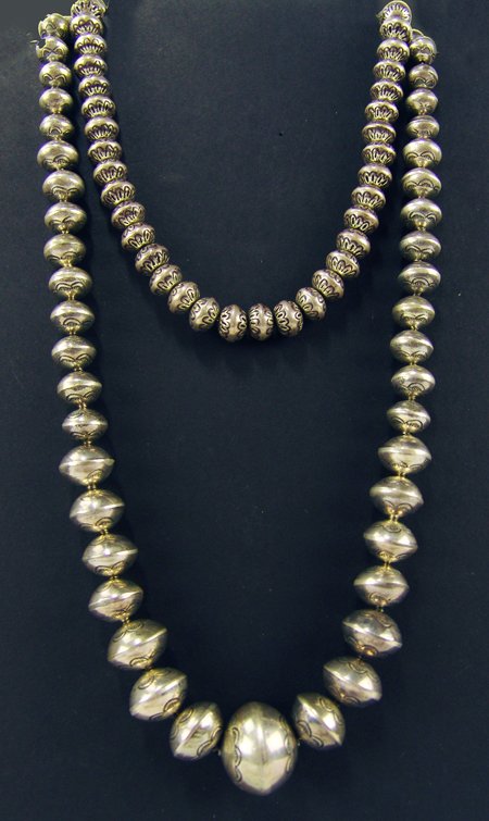 Navajo Beads - Preston Curley: Ca. 1970s-1980s, Two necklaces including a fine strand of hand wrought graduated stamped silver beads by Curley, plus a smaller strand, also bench made, signed "M Jones." (?) Both very good condition.