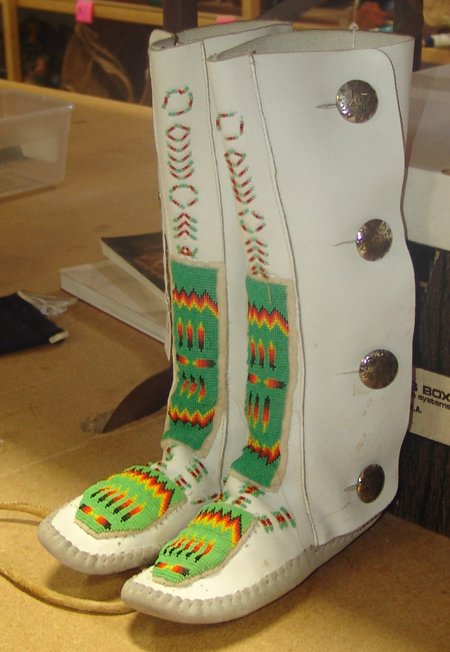 Navajo Beaded Moccasins: Ca. 1980s, Beautiful Navajo-made Plateau-style high-top moccasins with loom beaded designs done on sturdy white commercial buckskin. Very good condition. 9"