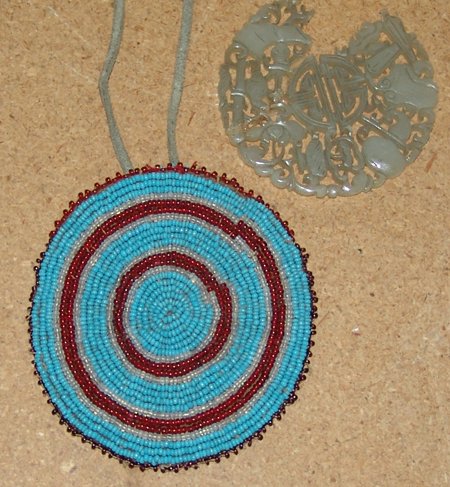 Plains Beaded Rosette Bag: Early 1900s, Beautiful little fully beaded rosette that was made into a small round bag. Includes a (broken) Chinese medallion. Very good condition. Rosette 3-3/4" x 3-1/2"