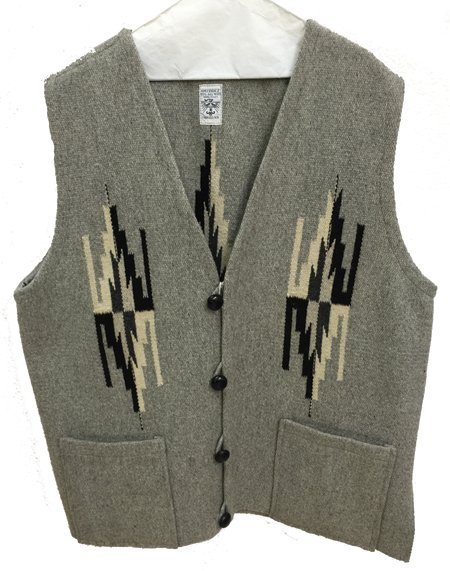 Chimayo Vest: Ca. 1990s, Splendid "Ortega" hand woven all natural gray, cream, and black vest with chevron motifs, leather buttons, and patch pockets. Good condition. Large - 32" x 24"