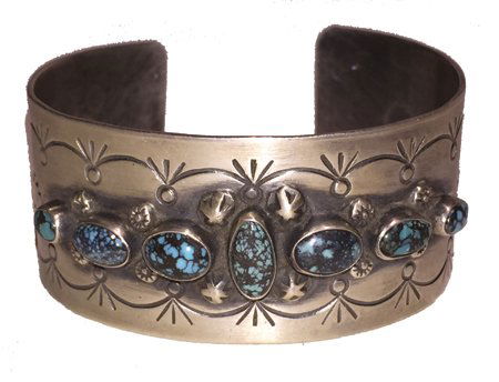 Navajo Bracelet: Late 1900s, Beautiful stamped silver cuff set with seven natural spiderweb turquoise stones. Good condition. 5-1/2" + 1/2" x 1"