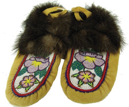Cree Beaded Moccasins: Ca. 1980s, Classic pair of beaver trimmed moosehide moccasins with beaded floral vamps. Very good condition. 10-1/2"