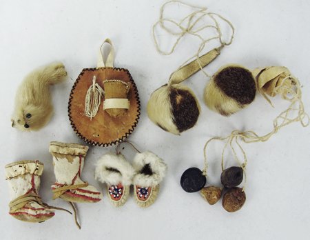 Box Lot of Eskimo Relics: Ca. 1950s-1980s, Includes sealskin "yo-yo," miniature mukluks and moccasins, two other toys with wood and/or bone attachments, plus a sewing kit with a thimble. All in good condition. Sewing kit 5" x 