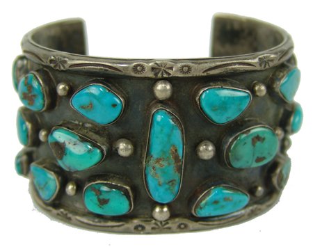 Navajo Bracelet: Ca. 1960s, Vintage hand wrought heavy silver wide cuff bracelet set with 19 naturally aged turquoise stones. Very good used condition, nice patina. Ex. Devil Dancer Collection, Missoula, MT. 5-7/8" + 
