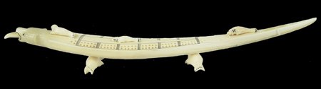 Eskimo Ivory Cribbage Board - Gabriel Payenna: Ca. 1980s, Finely carved polar bear cribbage board with carved seals and scrimshaw details. The bear's tongue is removable to store pegs. Seal stands on bottom are also removable. Very good condition.