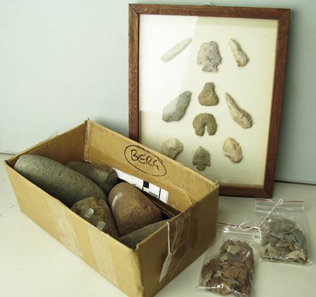 Arrowheads and Pestles: Various Ages, Here's your chance to buy, literally, a box of rocks: 10 points in shadowbox frame; 2 Columbia River stone tools; Ulu with bone handle, tag reads "c.1860"; a short pestle, tag reads "fou
