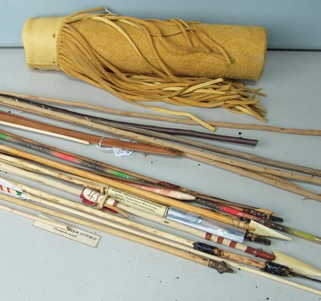 Bow, Arrows, and Quiver: Various Ages, An arrow quiver made from a commercially tanned, buckskin-covered cardboard tube, with fringe, 16 x 4"; 6 sticks which could be used to make arrows; a strung long bow, 28"; 13 arrows of