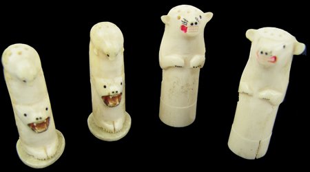 Eskimo Ivory Shakers: Mid 1900s, Two great pairs of hand carved salt and pepper shakers made from ivory, with scrimshaw and inked details. Good, usable condition. Tallest 3" x 1"