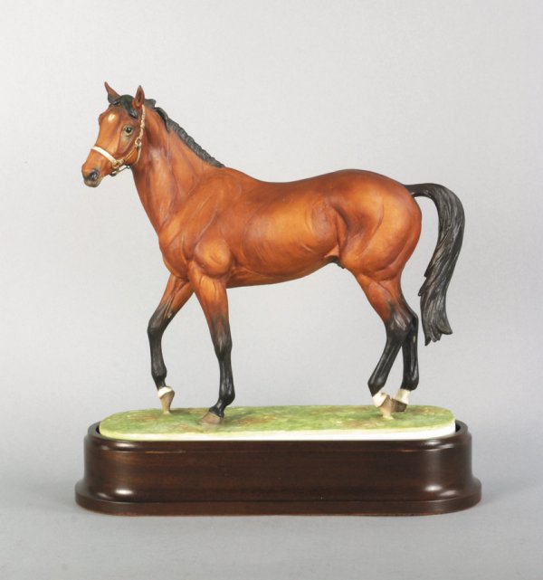 A Royal Worcester model of Nijinsky by Doris Lindn: A Royal Worcester model of Nijinsky by Doris Lindner, mounted on a polished wooden base, with original certificate numbered 160, and a sale receipt height 27.5cm., 10 3/4in. (3)