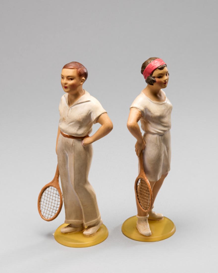 A rare pair of 1930s celluloid figurines of tennis: A rare pair of 1930s celluloid figurines of tennis players, early example of an artistic working in plastics, depicting a gentleman and lady player, height 16cm.