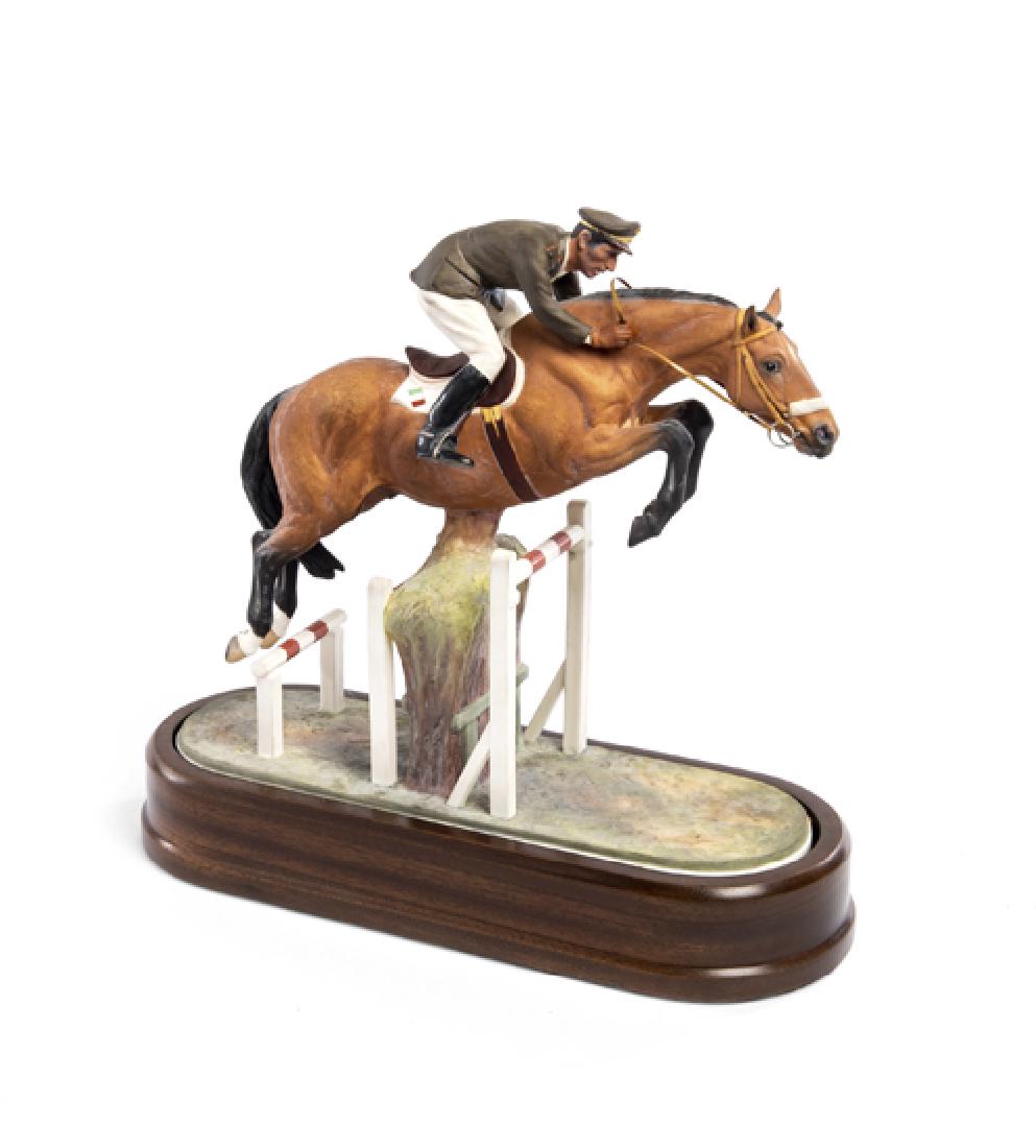 A Limited Edition Royal Worcester Capt Raimondo d'Inzeo: A Limited Edition Royal Worcester Capt Raimondo d'Inzeo and Merano porcelain figural group by Doris Lindner, circa 1963, modelled jumping over fences, raised upon a walnut oval base, bears factory mar