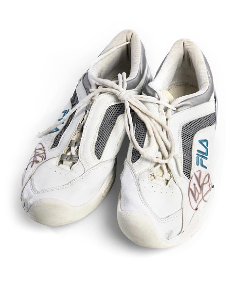 An autographed pair of FILA tennis shoes, signed by Kim: An autographed pair of FILA tennis shoes, signed by Kim Clijsters, the white leather shoes signed in black marker pen on the front of each, (pair), minor wear to front
