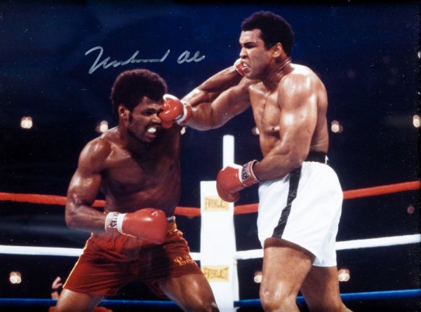 A group of four signed colour photographs of world: A group of four signed colour photographs of world heavyweight champions: Muhammad Ali, George Foreman, Larry Holmes and Ken Norton, all with a COA to the back of the frame, all signatures in marker p