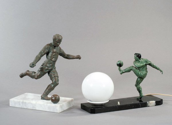 A spelter figure of a footballer, greenish brown p