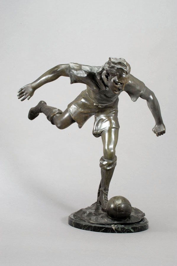 A large spelter figure of a footballer, the base s