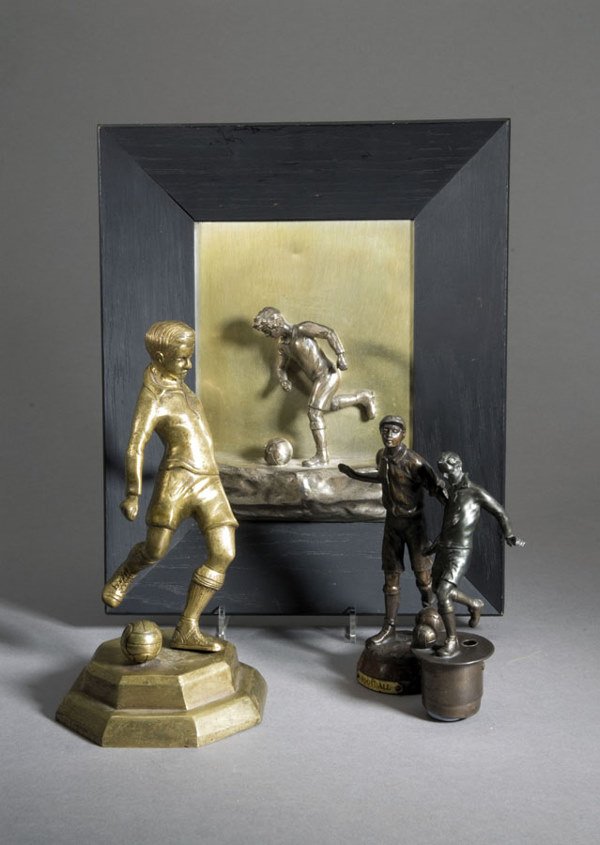 Four football figures, one in brass, one in spelte