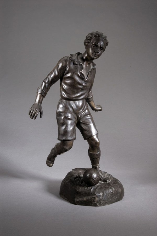 A large spelter figure of a footballer, signed S K