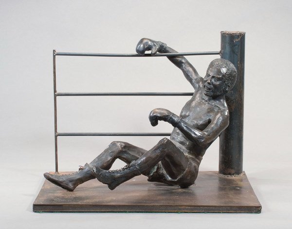 A large bronze portraying a boxer on the canvas in