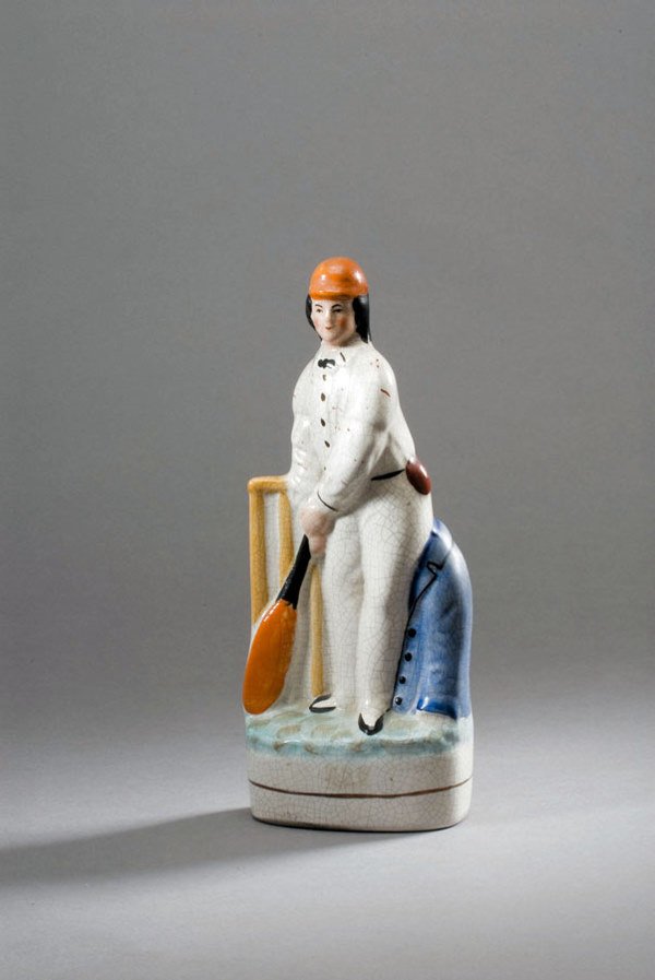 A Staffordshire flatback figure of a cricketer mid