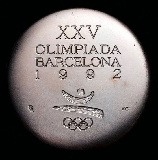 A 1992 Barcelona Olympic Games participation medal: A 1992 Barcelona Olympic Games participation medal, designed by Xavier Corbero, Olympic emblem and stylised jumping athlete, reverse with spiral & lightning bolt, in original presentation pouch