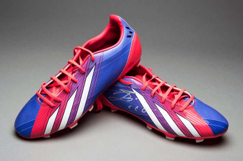 A Lionel Messi signed pair of football boots, purple &: A Lionel Messi signed pair of football boots, purple & red Adidas Performance F10 Trx Fg boots both inscribed MESSI, signature to the right side of the right boot in silver marker pen