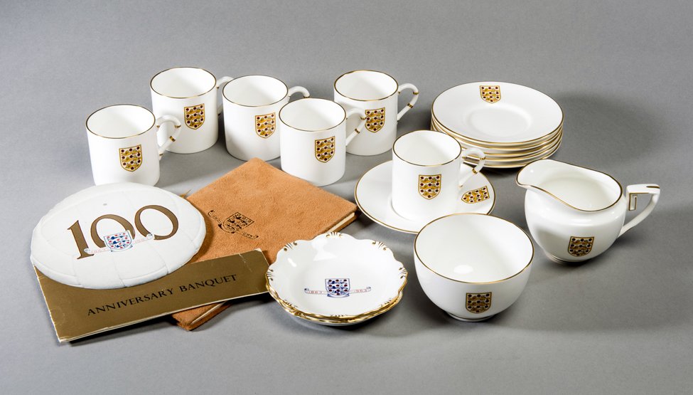 A Football Association coffee set, Royal Worcester bone: A Football Association coffee set, Royal Worcester bone china, comprising six coffee cups & saucers, a creamer & a sugar bowl, all with the Football Association crest, in original box; together with a