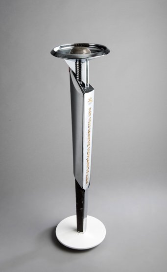 A 1992 Barcelona Olympic Games bearer's torch, designed: A 1992 Barcelona Olympic Games bearer's torch, designed by Andre Ricard, manufactured by Kromschroder, length 68cm. 26 3/4in., weight 1,200gr., later fitted onto a stand