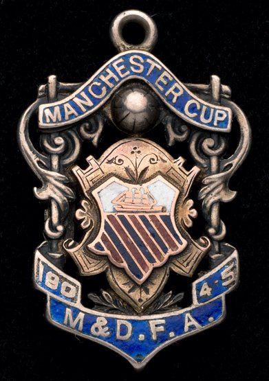 Charlie Roberts Manchester United captain: a Manchester: Charlie Roberts Manchester United captain: a Manchester Senior Cup runners-up medal 1904-05, 9ct. gold mounted silver & enamel medal, inscribed M & D.F.A, MANCHESTER CUP 1904-05, MANCHESTER UNITED, RU