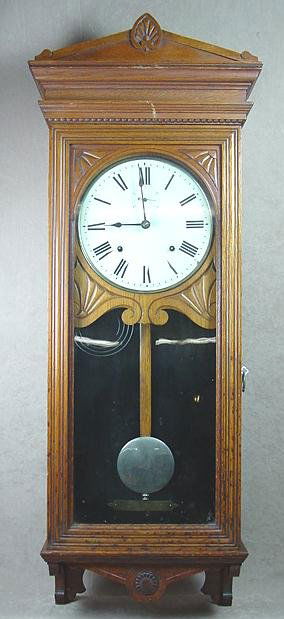 BUNDY WALL REGULATOR CLOCK: Oak case, 45" long, time & strike, original key, Bundy preceded IBM. They used Seth Thomas movements as this clock has. Movement is marked SUEZ along with Seth Thomas.