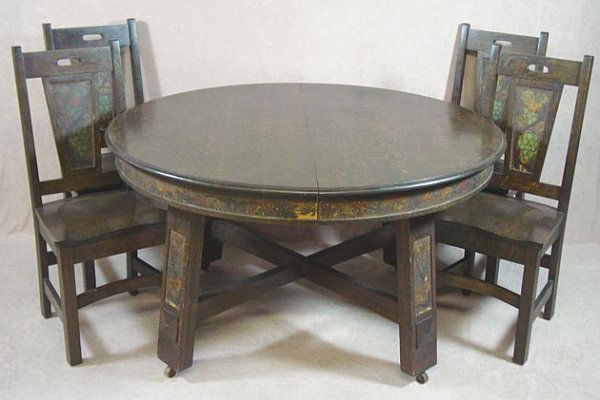 ARTS & CRAFTS OAK & LEATHER DINING ROOM SET: Purchased new in 1911. Includes 54" round top 4 leg extension table, rack of 5 leaves, 4 solid seat side chairs, Buffet 58" Wide, 51" High. Hand painted leather panels inset on all pieces, Buffet w/ m