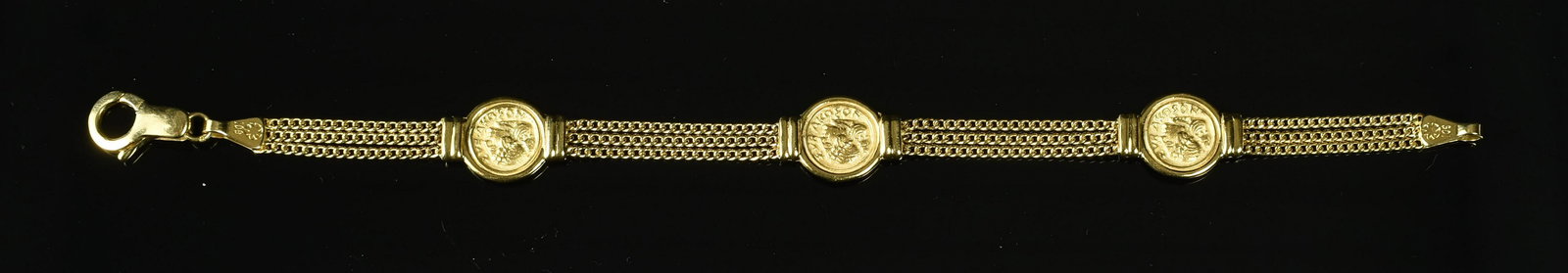 Extremely Fine Vintage 14K Gold Coin Bracelet: Possibly a one-of-a-kind. Unable to find any comparables. Features 3 Greek coin images depicting a helmuted Athena on the obverse with greek letters and a classical Greek lady in profile on the revers