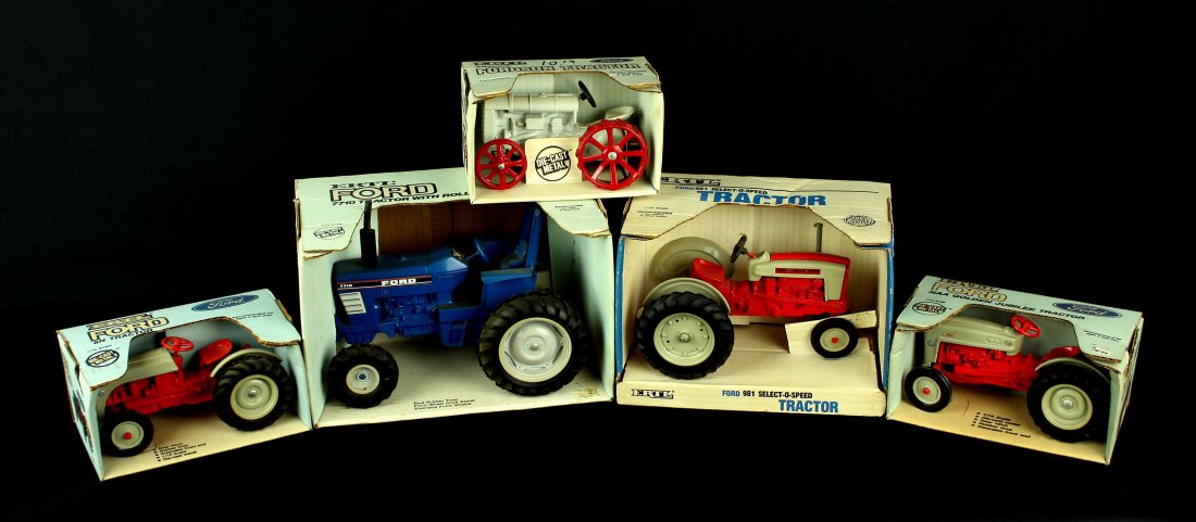 5 1/16th scale Ford Tractors by Ertl. Die Cast New In: Assortment of Ertl Die Cast toy Ford Tractors from the Nick Hadden Collection of Vintage Toys and Models. Includes following models, all in 1/16th scale. 7710 Tractor with rollbar, 981 Select-O-Speed,