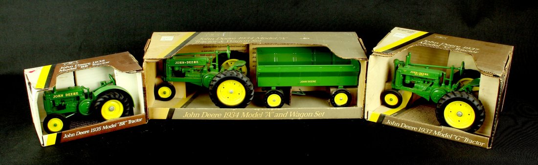 3 Nice John Deere 1930's Model Tractor Toys by Ertl: New in Boxes 1934 Model 'A' with Wagon, 1935 Model 'BR', and a 1937 Model 'G' Tractors. All by Ertl and die cast. In new or near new condition and appear to have never been out of their original boxes