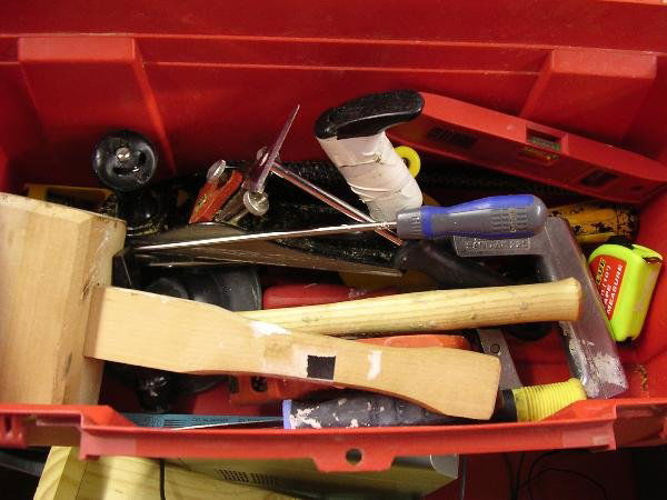 692: 'SYD'S' BASIC TOOL KIT, COMPRISING A HACKSAW,: Syd's' basic tool kit, comprising a hacksaw, mallet, plane, chisel, hammer, screwdrivers and a spirit level, all contained within a red plastic tool box It was with these basic tools and few power too
