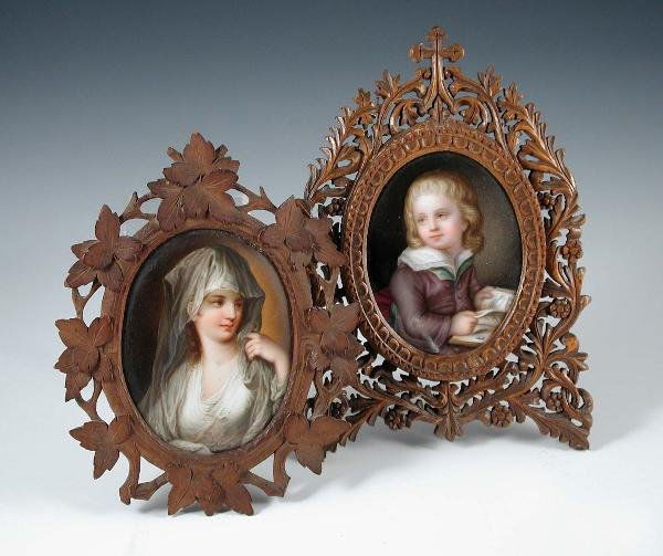 TWO DRESDEN PLAQUES IN VINE FRAMES: Two mid 19th century Dresden plaques in vine carved frames with easel backs, one of the ovals painted with a vestal virgin, 8cm high and the other with a boy reading, 7.5cm high (2)