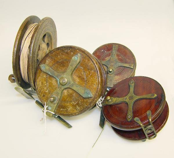 FOUR DECORATIVE WOODEN REELS: Heaton - a wooden patent 'Sun' reel with logo and three other decorative wooden reels (4)